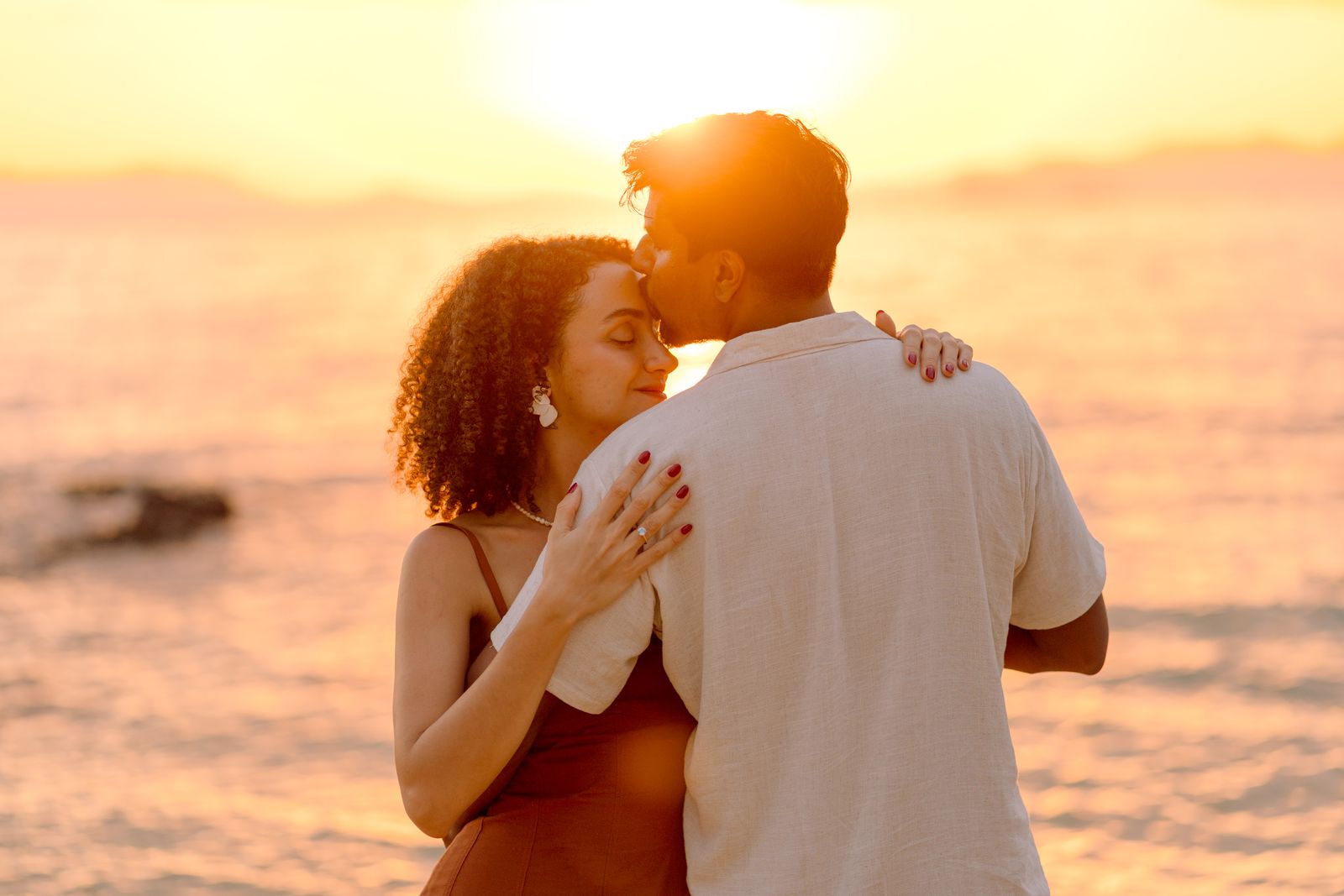 Larissa and Nihal embracing at sunset